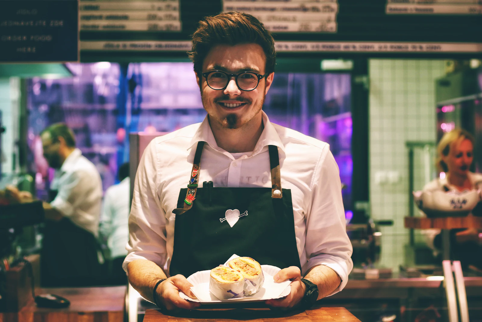 Dueño de un restaurante con un plato en la mano